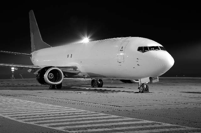 Aircraft parked on a runway at night